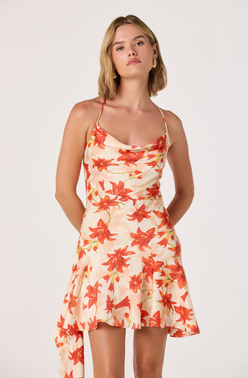 Cream dress with orange floral print, spaghetti straps, and asymmetrical hem.