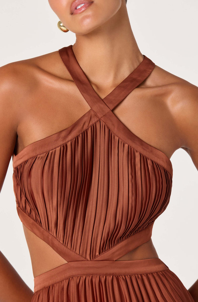 Brown pleated halter dress with wide satin straps crossing at the chest.