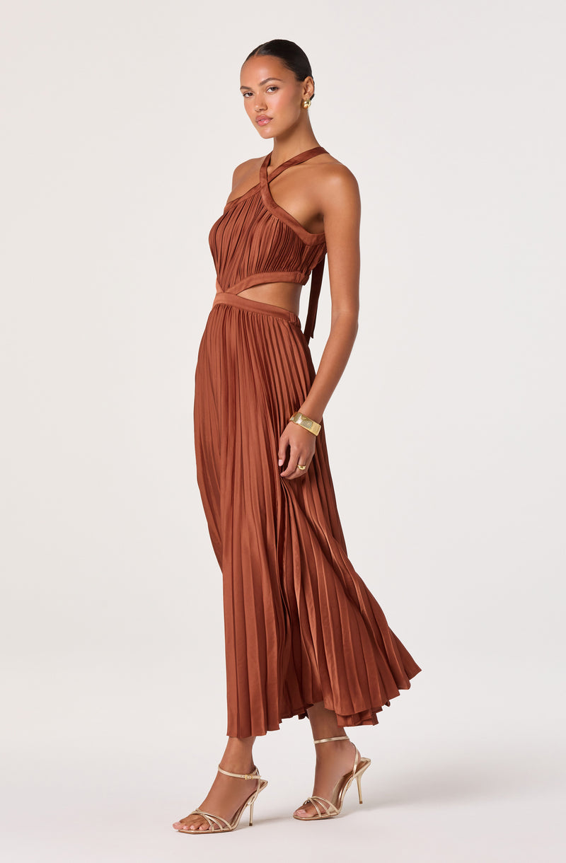 Bronze pleated two-piece outfit with a halter top and wide-leg skirt, paired with strappy heels.