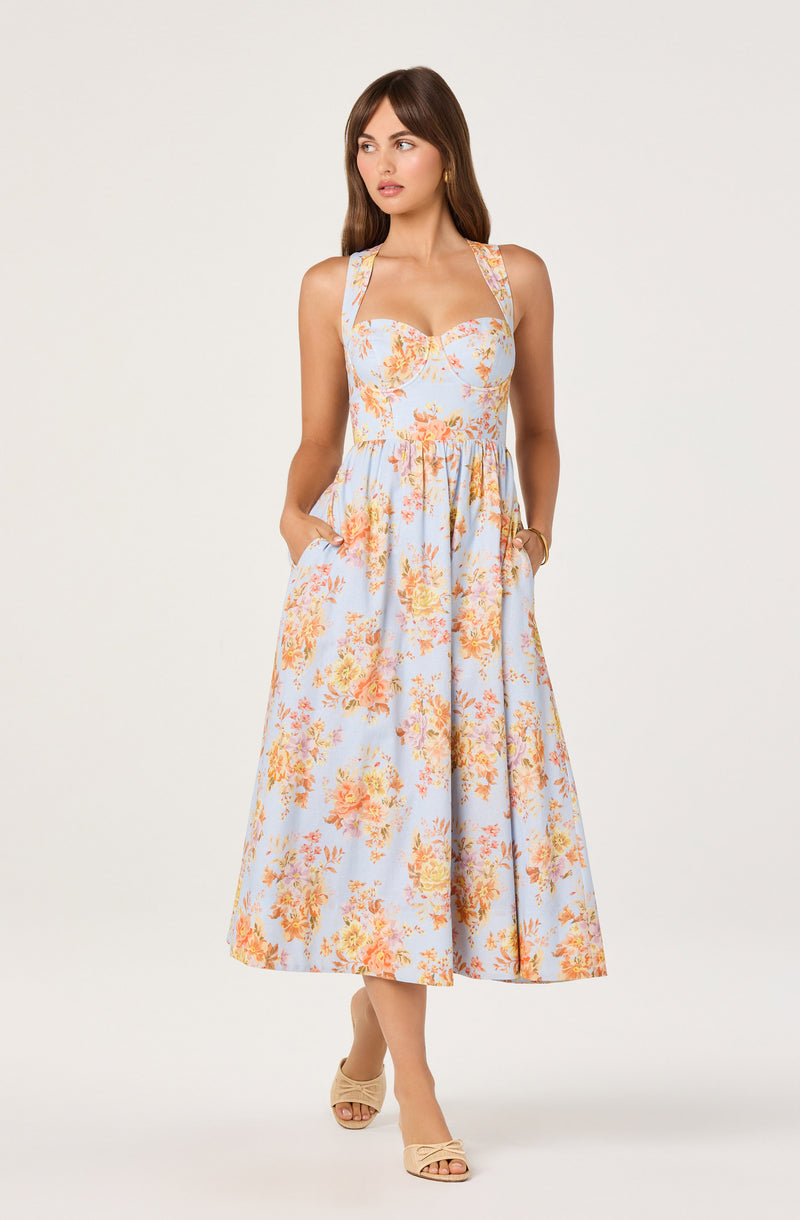 Sleeveless dress with a fitted bodice and a full, floral-patterned skirt.