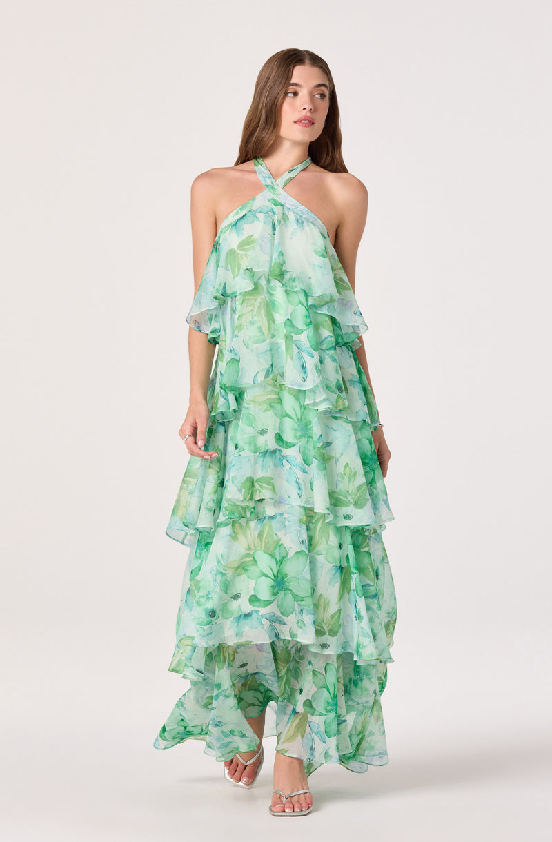 Long green and blue floral layered halter dress with ruffles and a flowy silhouette.