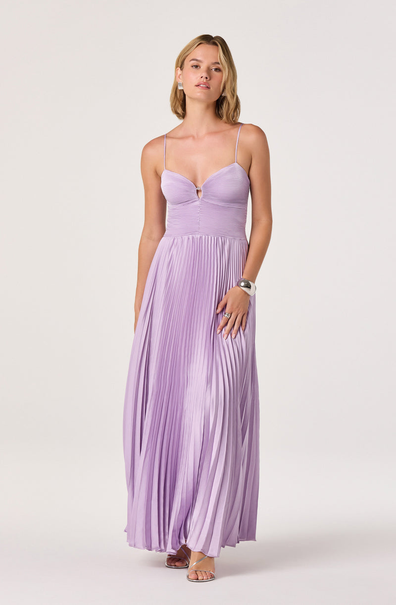 Woman in a lavender pleated maxi dress with spaghetti straps and a keyhole neckline.