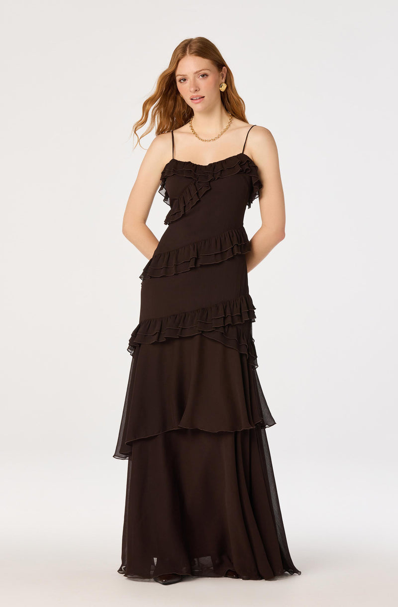 Black dress with ruffled layers and spaghetti straps, full-length style.