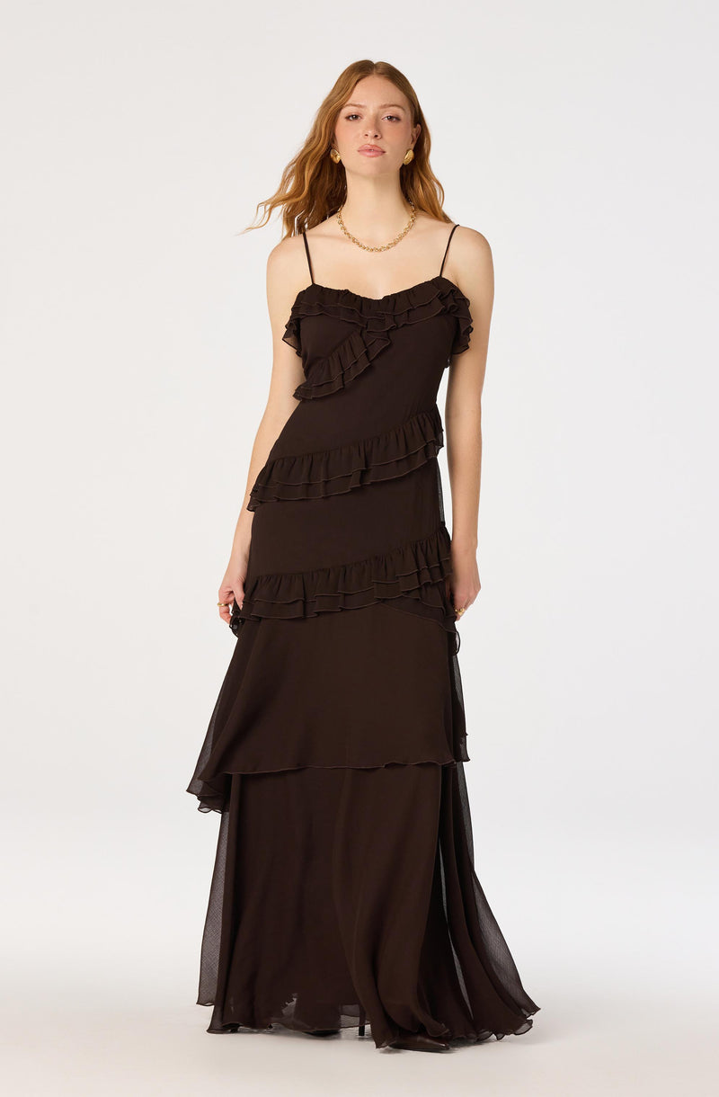 Long black dress with ruffled layers, spaghetti straps, and a sheer flowing skirt.
