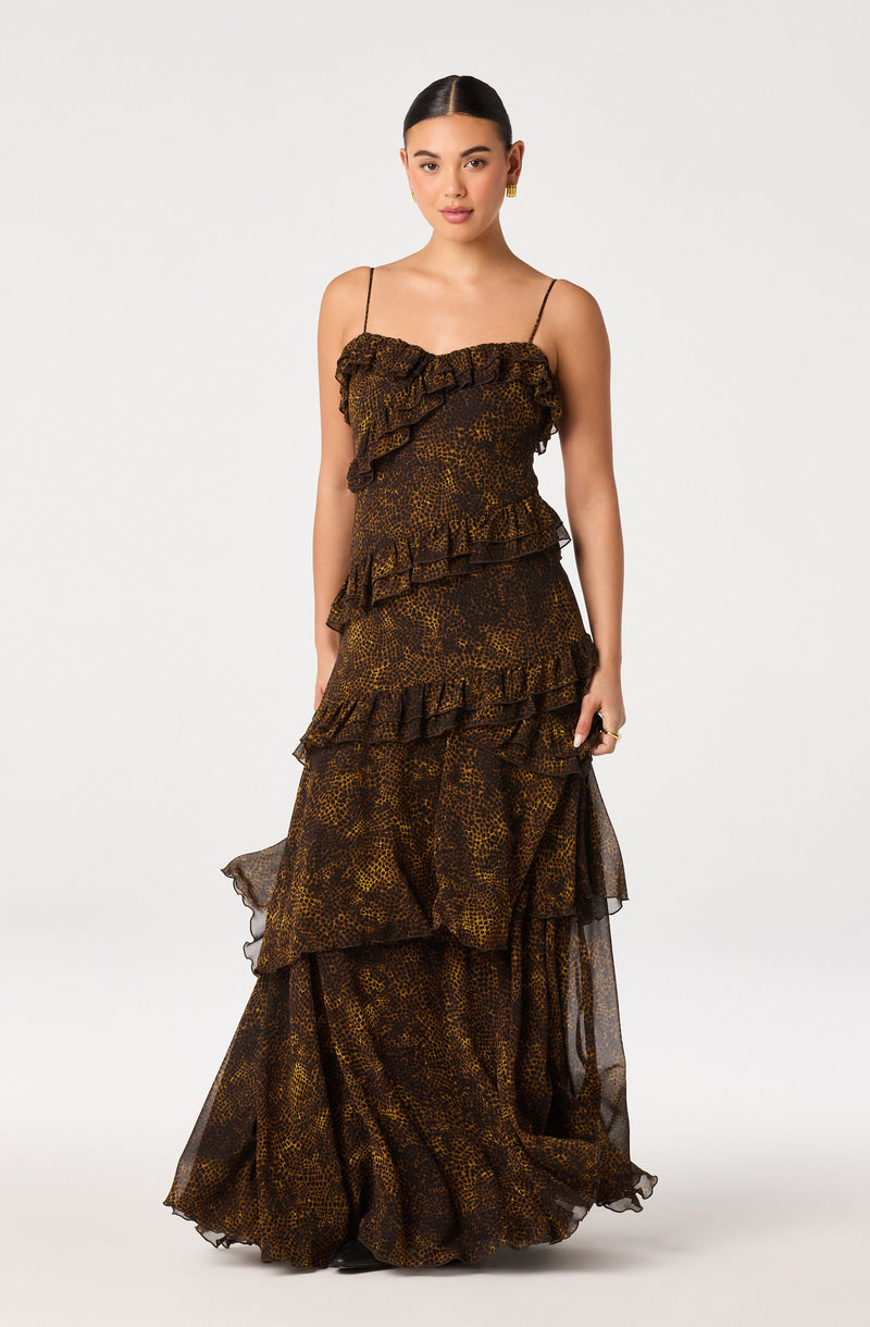 Women wearing a long, tiered, ruffled dress with a leopard print pattern and spaghetti straps.