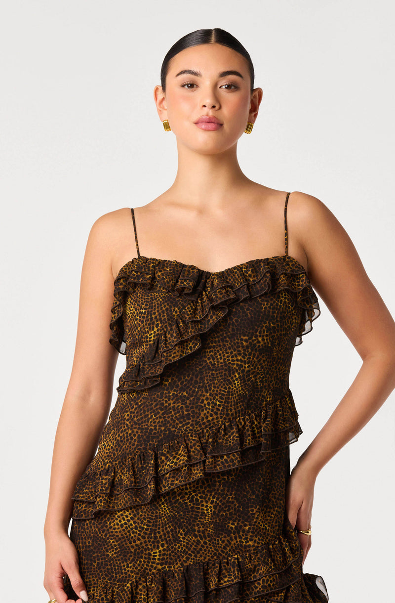 Woman in a leopard print dress with ruffles, spaghetti straps, and a fitted silhouette.
