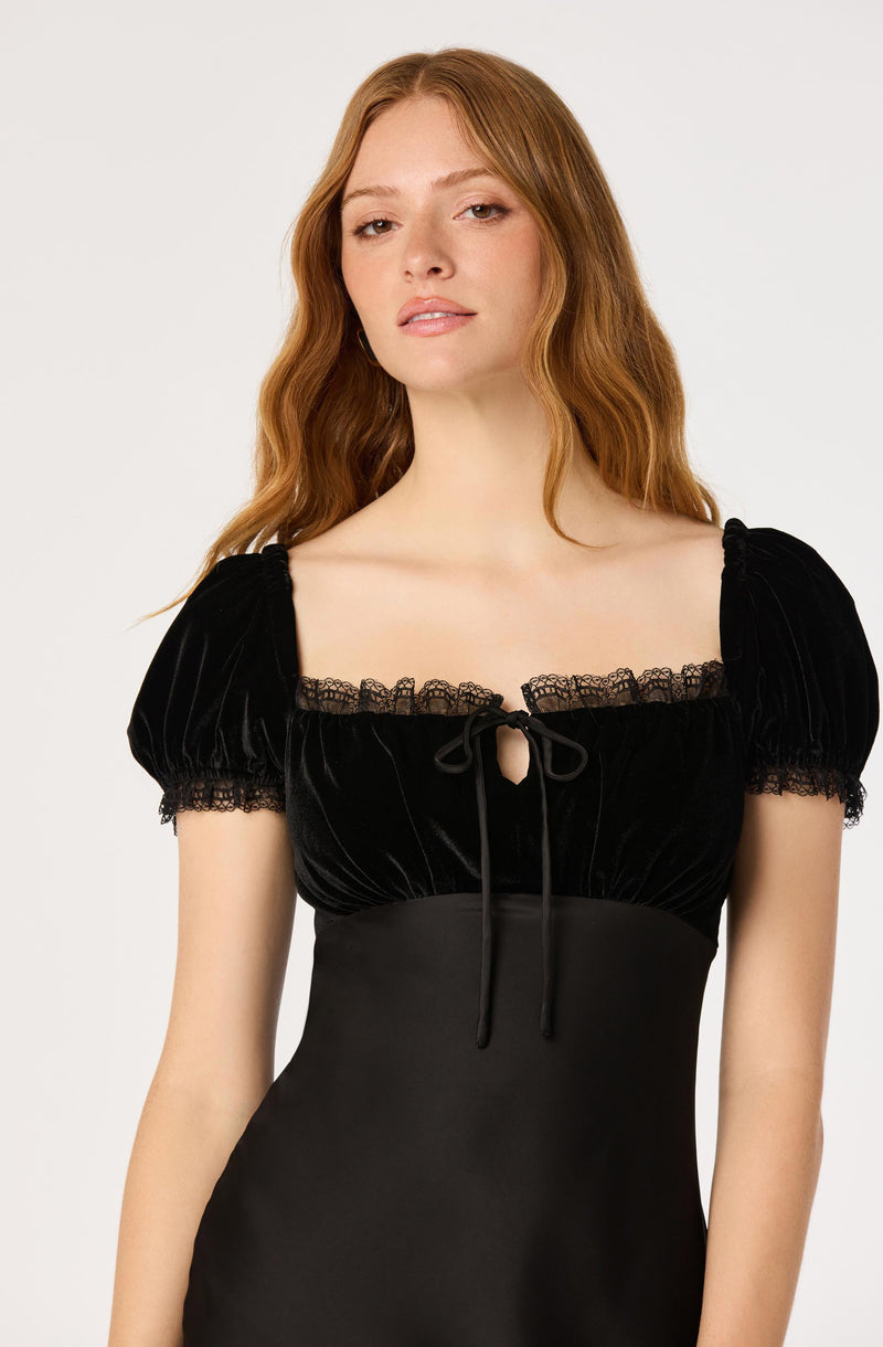 Black velvet top with puff sleeves, lace trim, and a front tie detail.