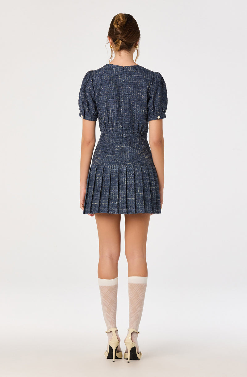 Blue textured short dress with puffed sleeves and pleated skirt.