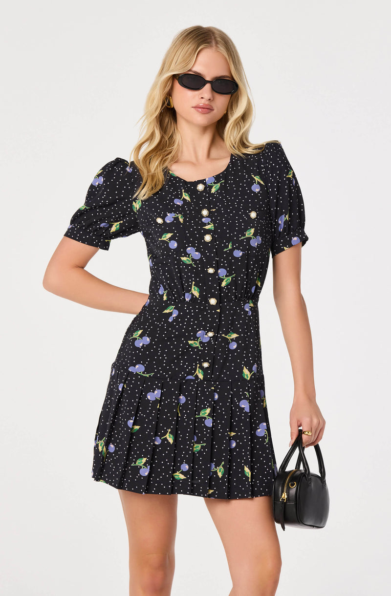 Black dress with puff sleeves, floral pattern, and pleated skirt.