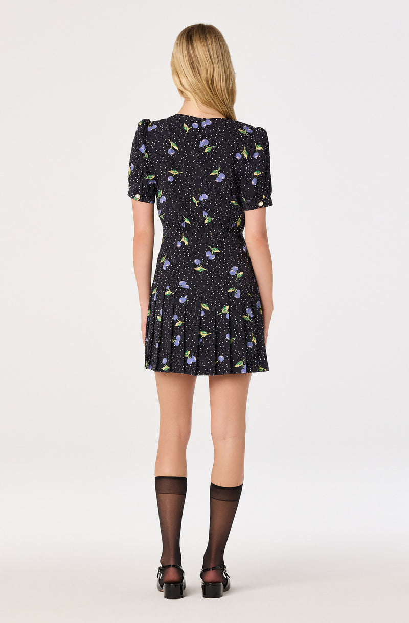 Black dress with puffed short sleeves, floral print, and a pleated skirt.