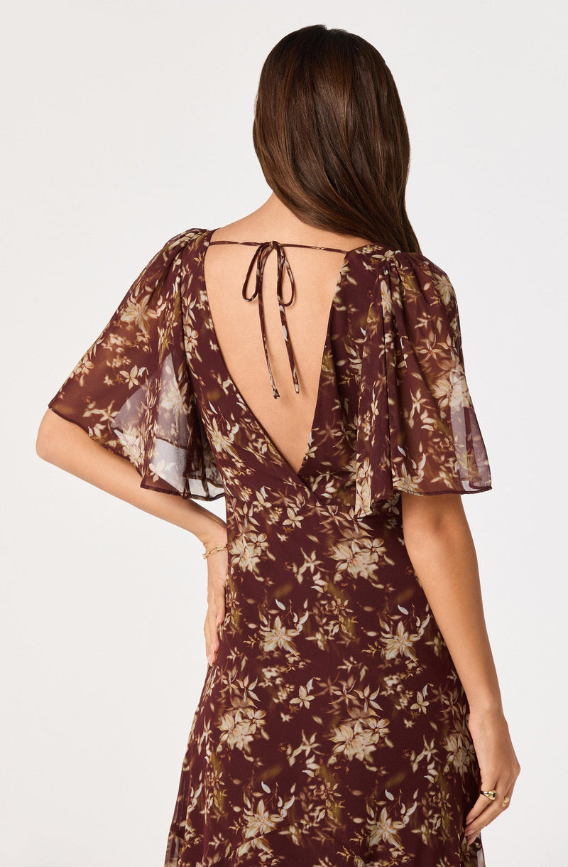 Brown floral dress with puff sleeves and a deep V-back tied at the neck.