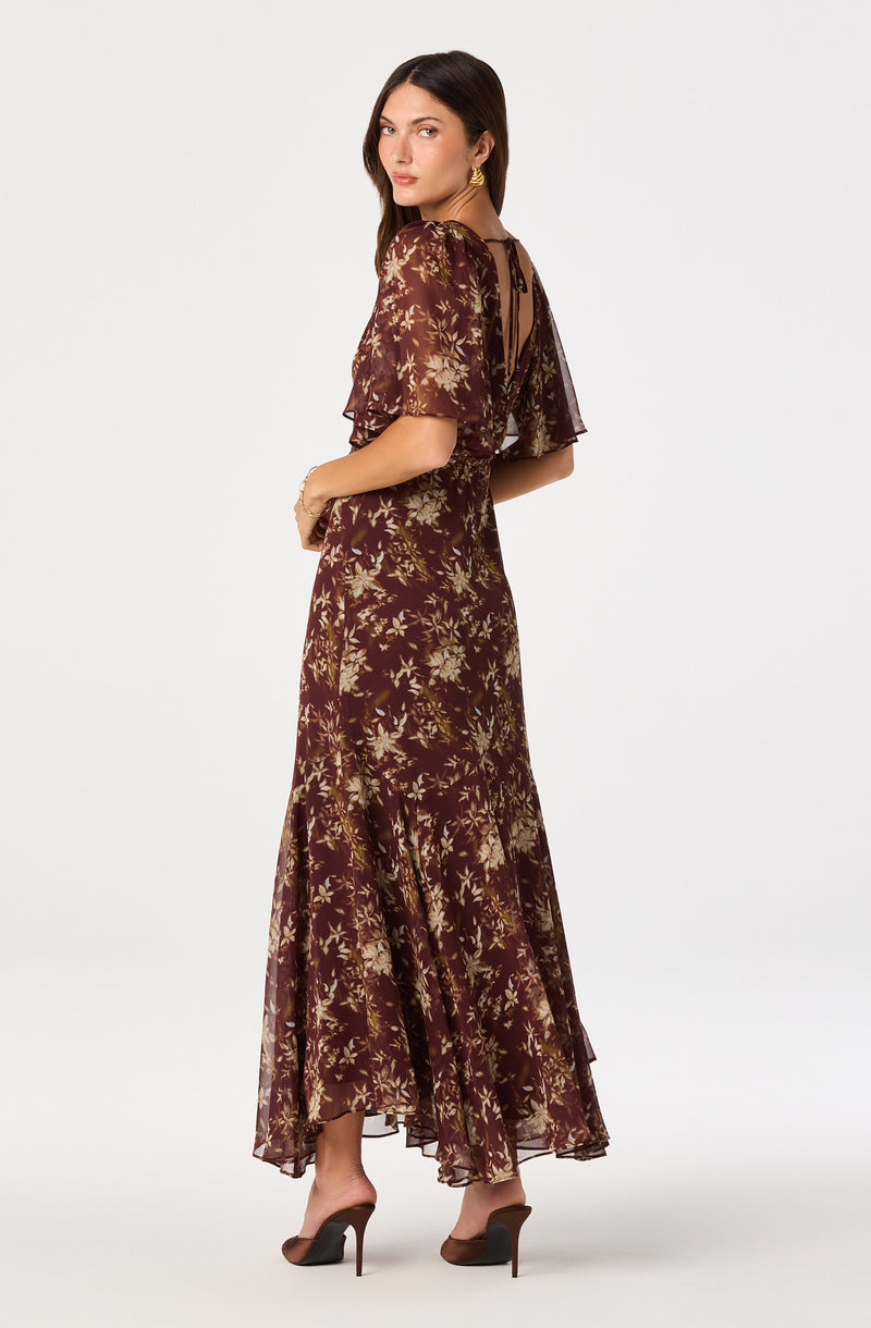 Long floral dress with sheer puff sleeves and a tie-back neckline.
