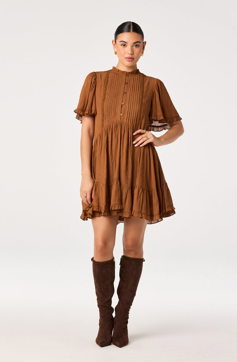 Brown dress with puff sleeves, ruffled hem, and vertical pleats on the front.