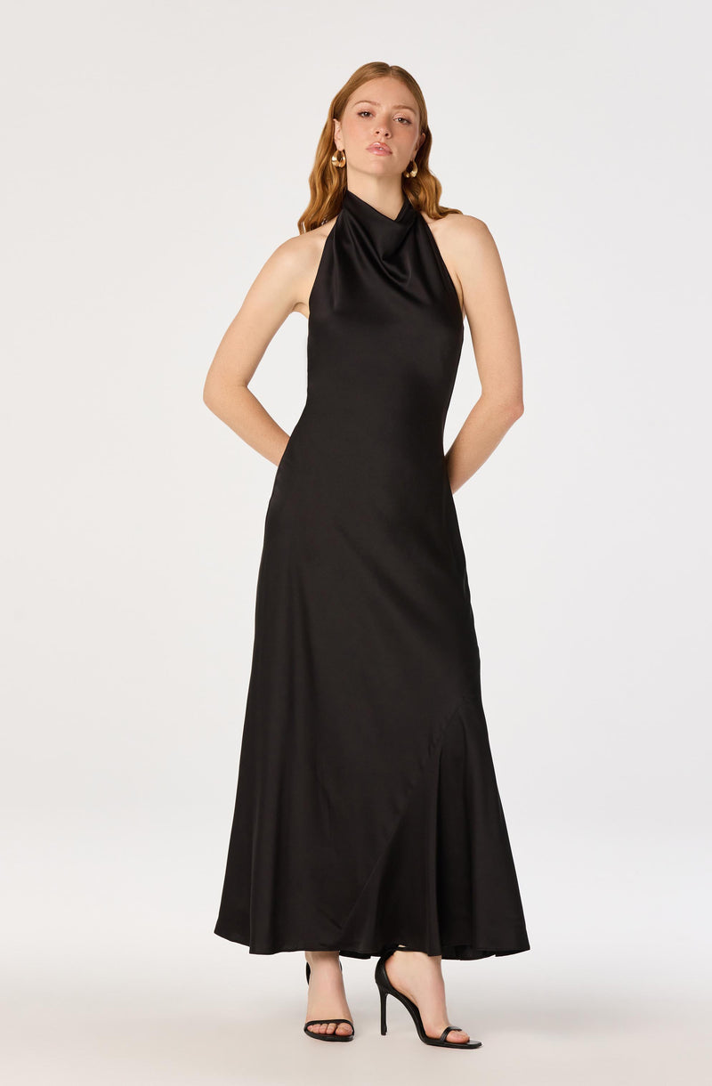 Long black satin evening dress with a halter neckline and a slit at the bottom.