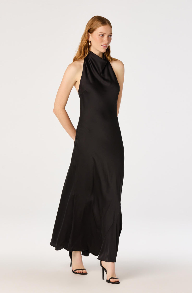 Woman in a long, black satin sleeveless gown with a high neckline.