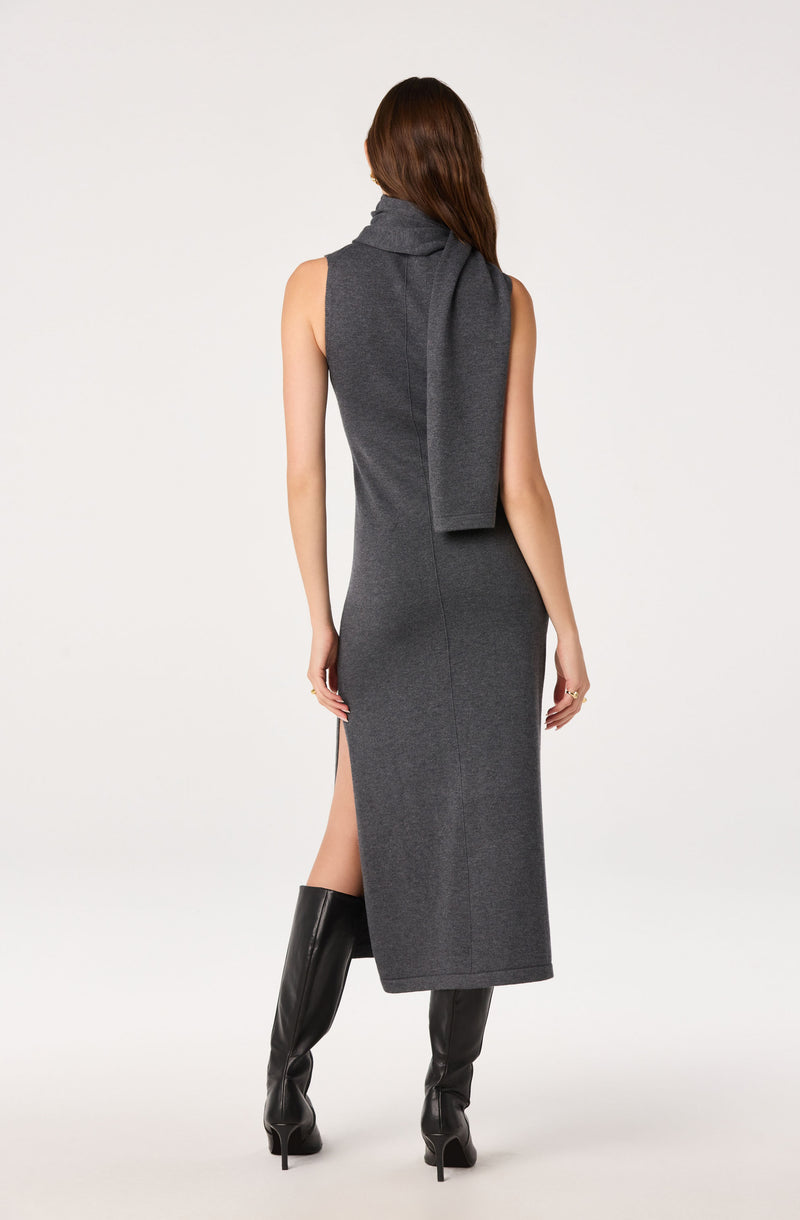 Woman in a sleeveless, gray, high-neck, midi dress with a slit and matching scarf.