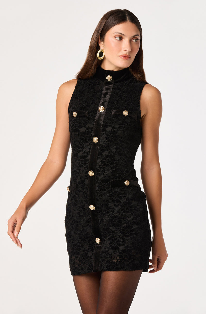 Black sleeveless dress with gold buttons and textured fabric.