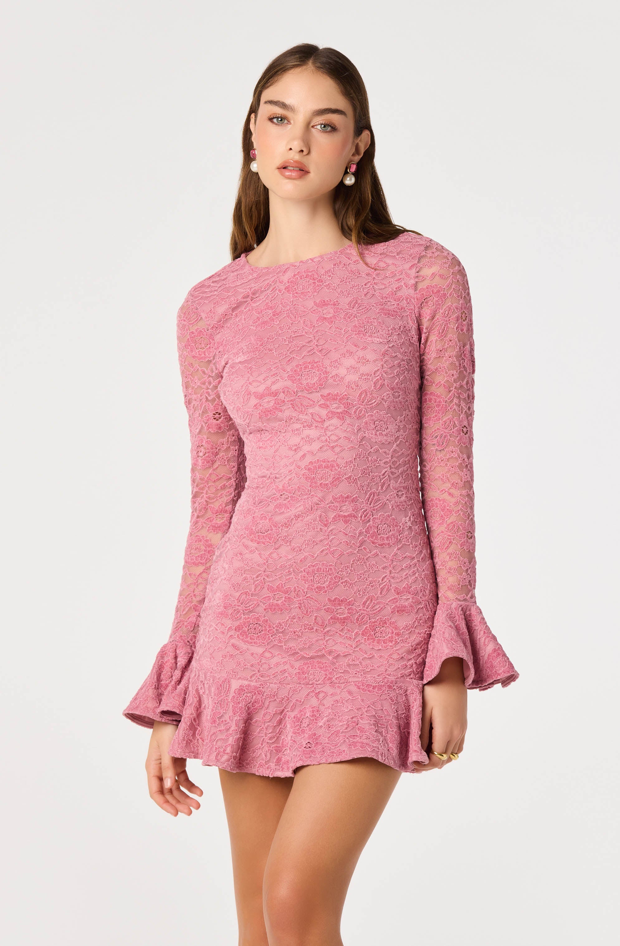 Pink lace dress with long sleeves and ruffled hem and cuffs.