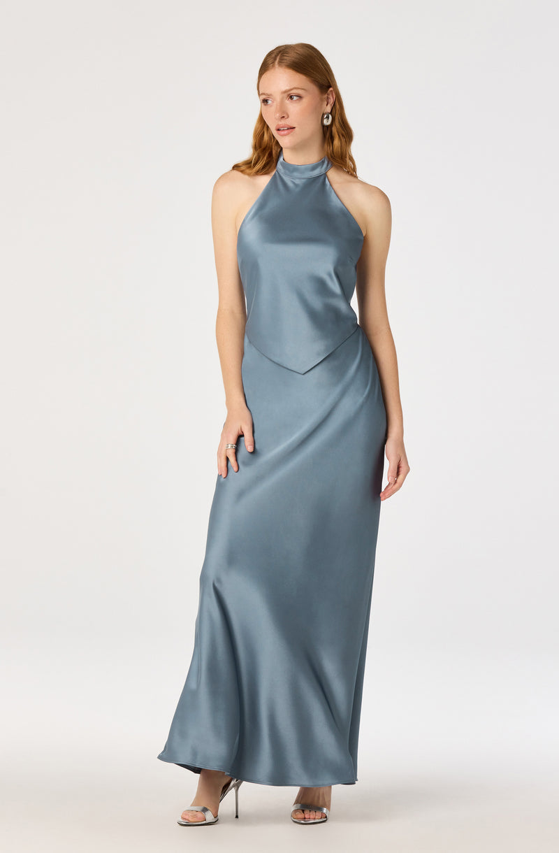 Woman in a shiny, light blue satin halter neck gown with a fitted waist and floor-length skirt.