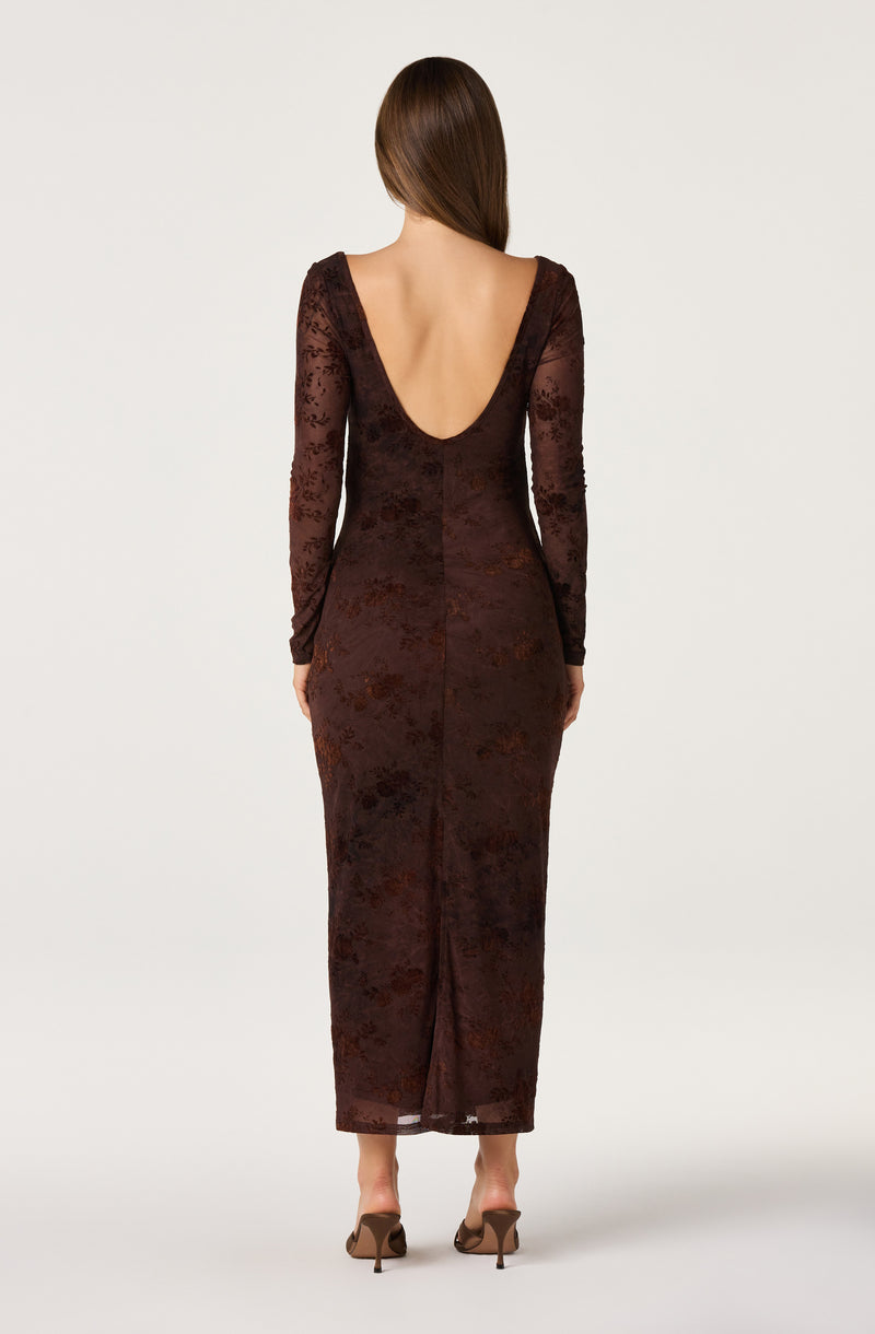 Back view of a woman wearing a long, dark brown floral lace dress with a deep V back.