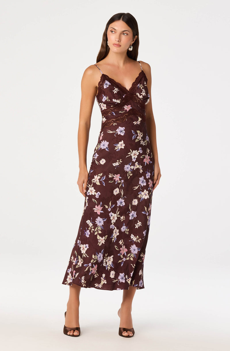 Sleeveless maxi dress with floral pattern, lace trim neckline, and spaghetti straps.