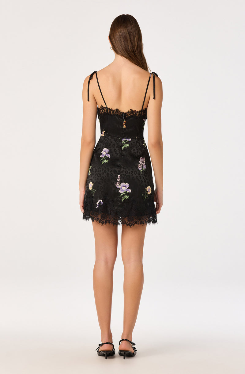 Black dress with floral embroidery, lace details, and spaghetti straps.