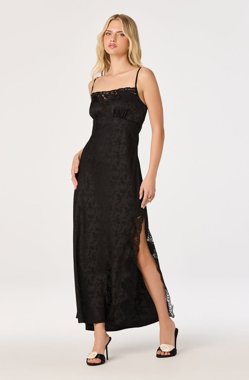 Long black lace and satin slip dress with spaghetti straps and a high slit.