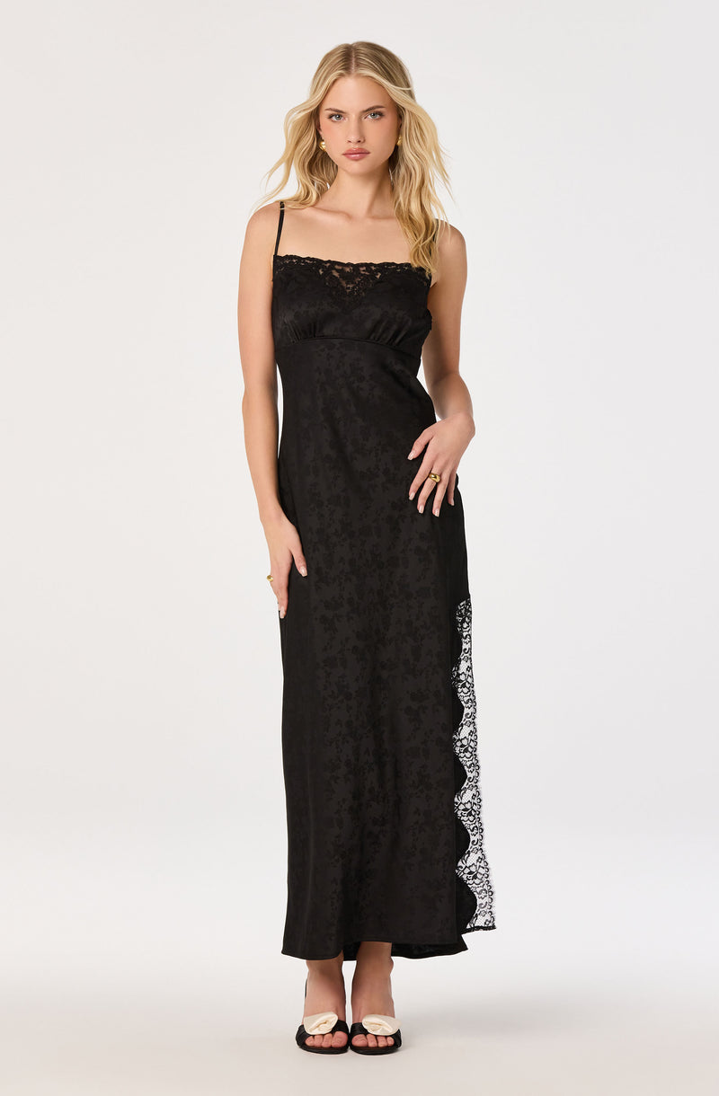 Long black dress with lace accents and spaghetti straps, halter neckline.
