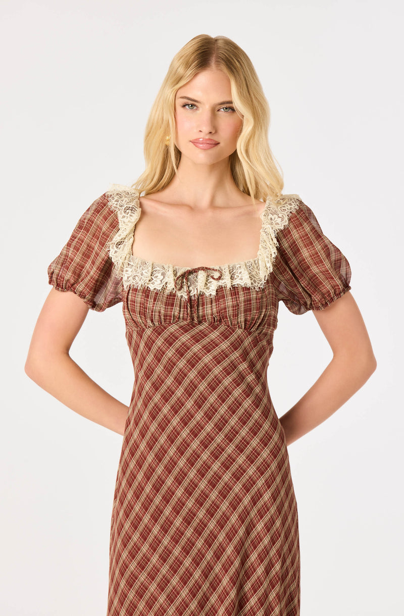 Red plaid dress with puffed sleeves and lace trim around the neckline.