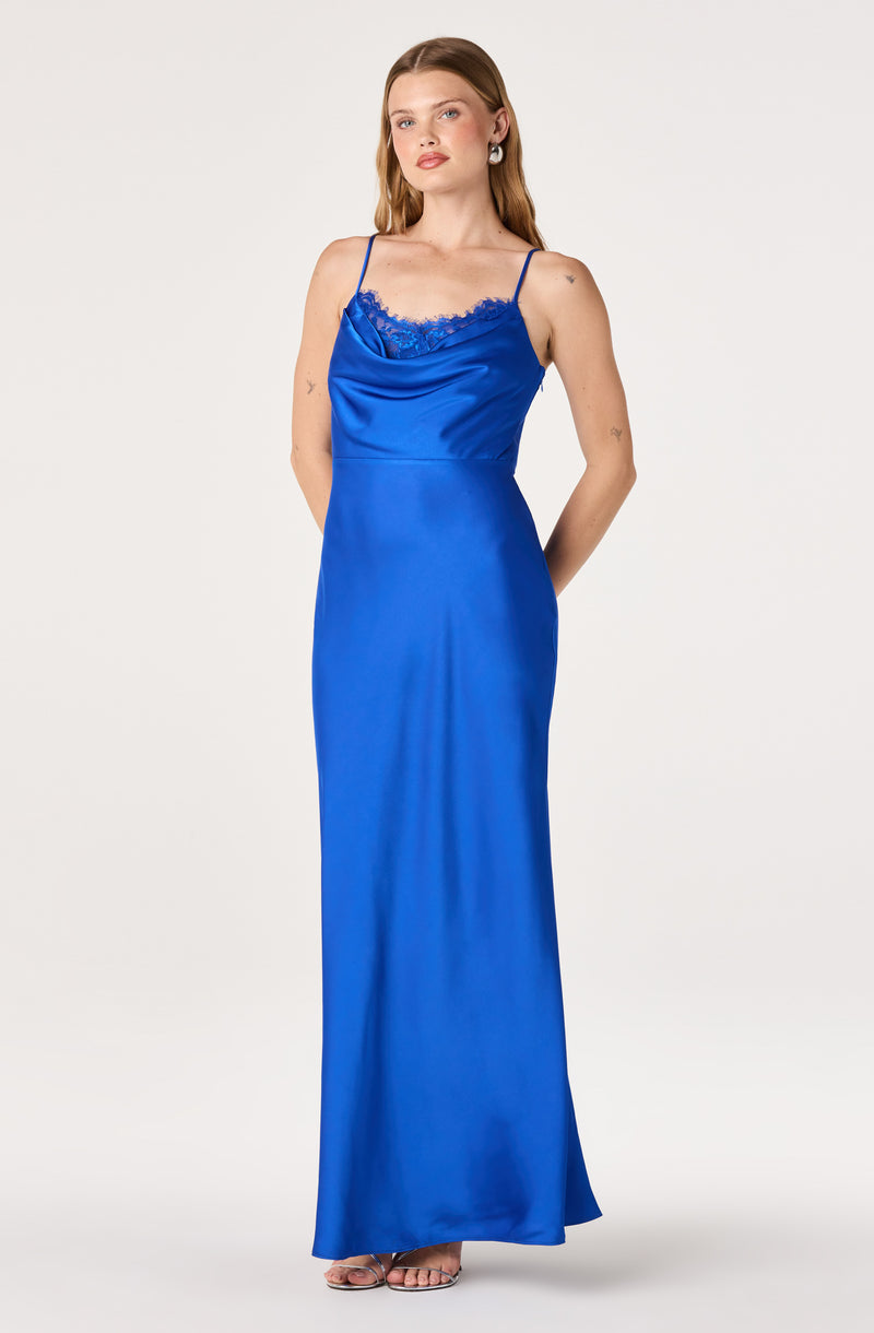 Woman in a long, royal blue satin slip dress with spaghetti straps and lace trim neckline.