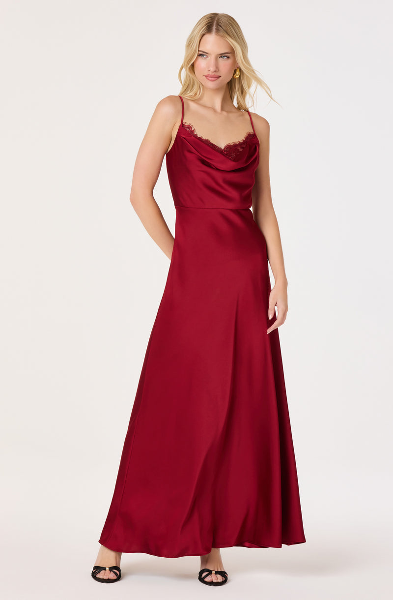 Woman in red satin evening dress with lace trim, spaghetti straps, and a floor-length skirt.
