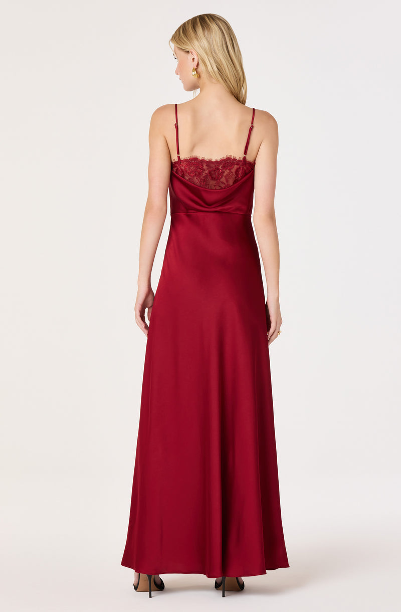 Woman in a long, red satin slip dress with lace details and spaghetti straps.