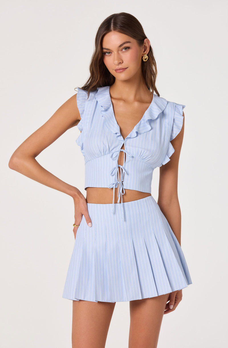 Light blue and white pinstriped sleeveless top with ruffled shoulders and front tie, paired with a matching pleated skirt.