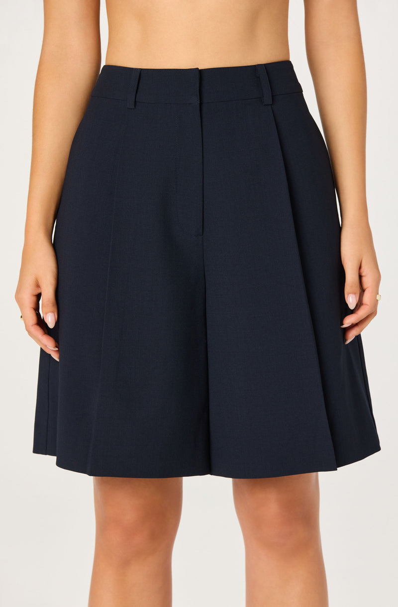 Navy pleated skirt with a high waist and belt loops.