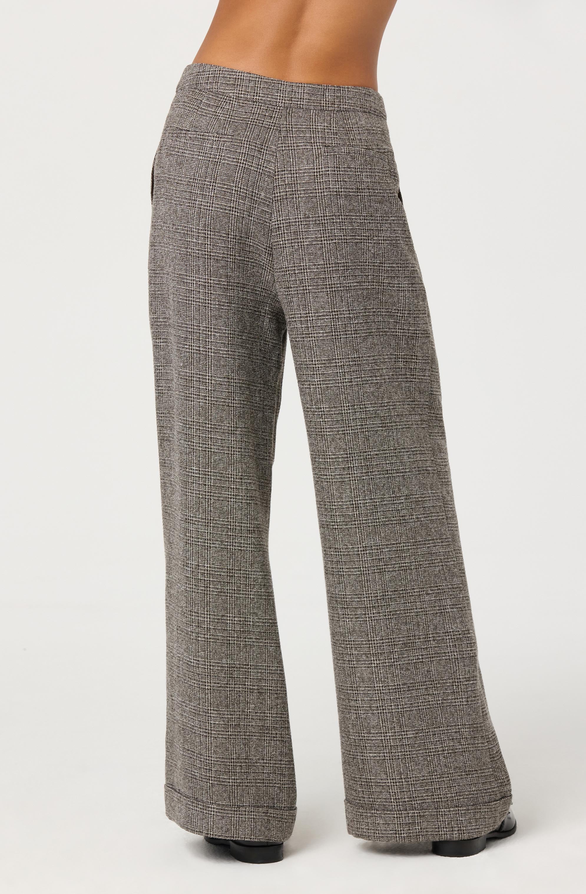 Gray plaid wide-leg pants with a high waist, featuring a classic checkered pattern in shades of black, white, and gray. The pants have a tailored fit through the hips and thighs, flaring out into a loose, flowing leg.