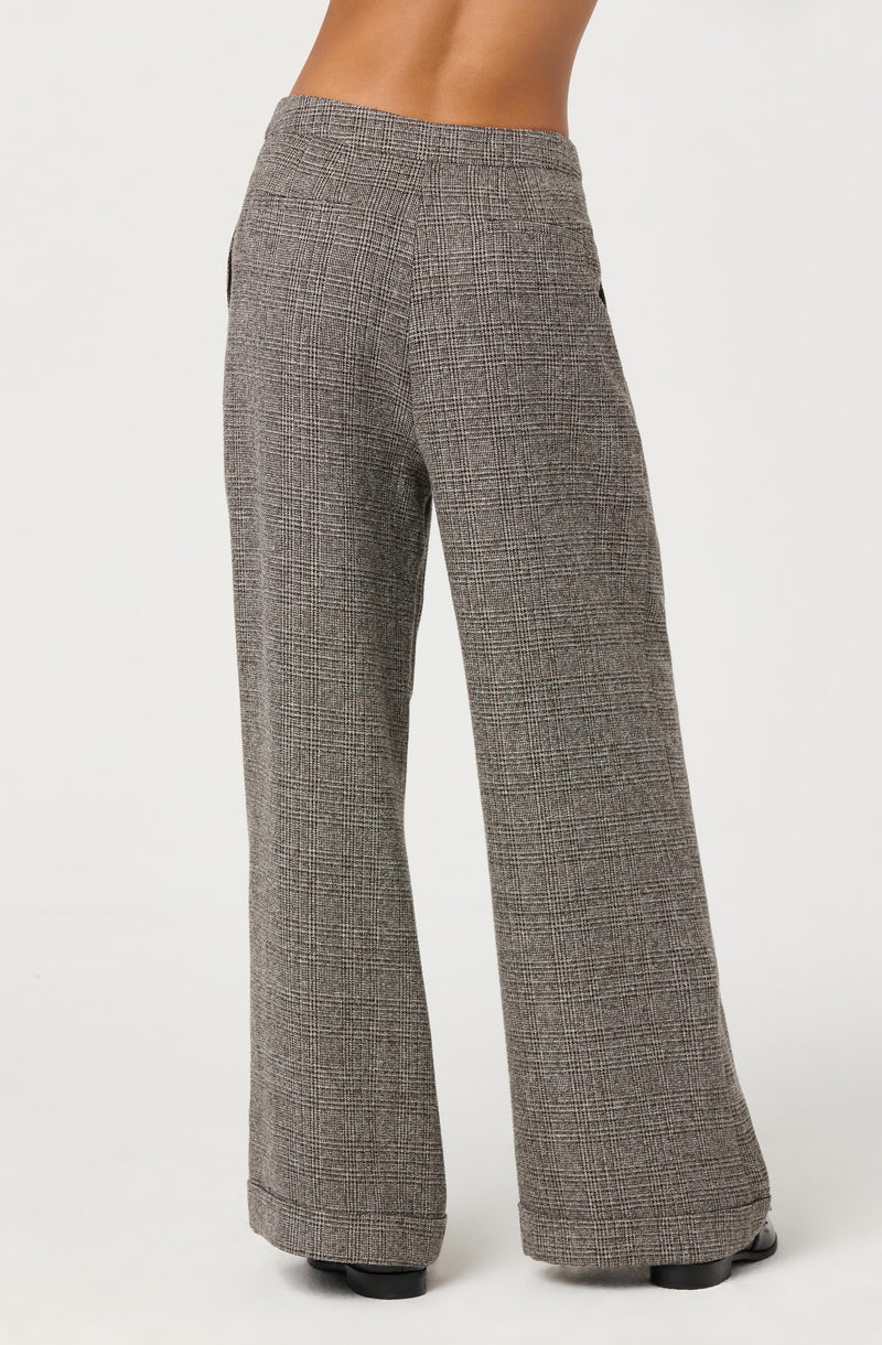 Gray plaid wide-leg pants with a high waist, featuring a classic checkered pattern in shades of black, white, and gray. The pants have a tailored fit through the hips and thighs, flaring out into a loose, flowing leg.