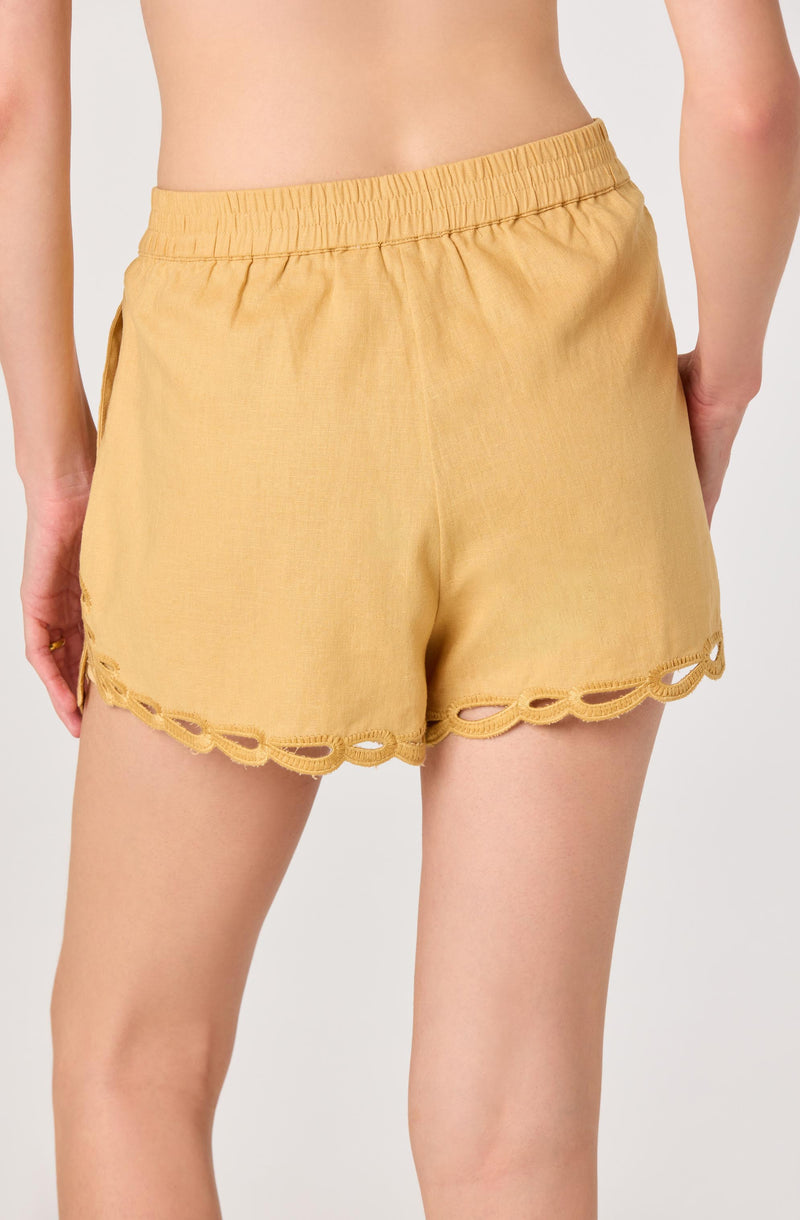 Yellow shorts with scalloped lace trim at the hem and an elastic waistband.