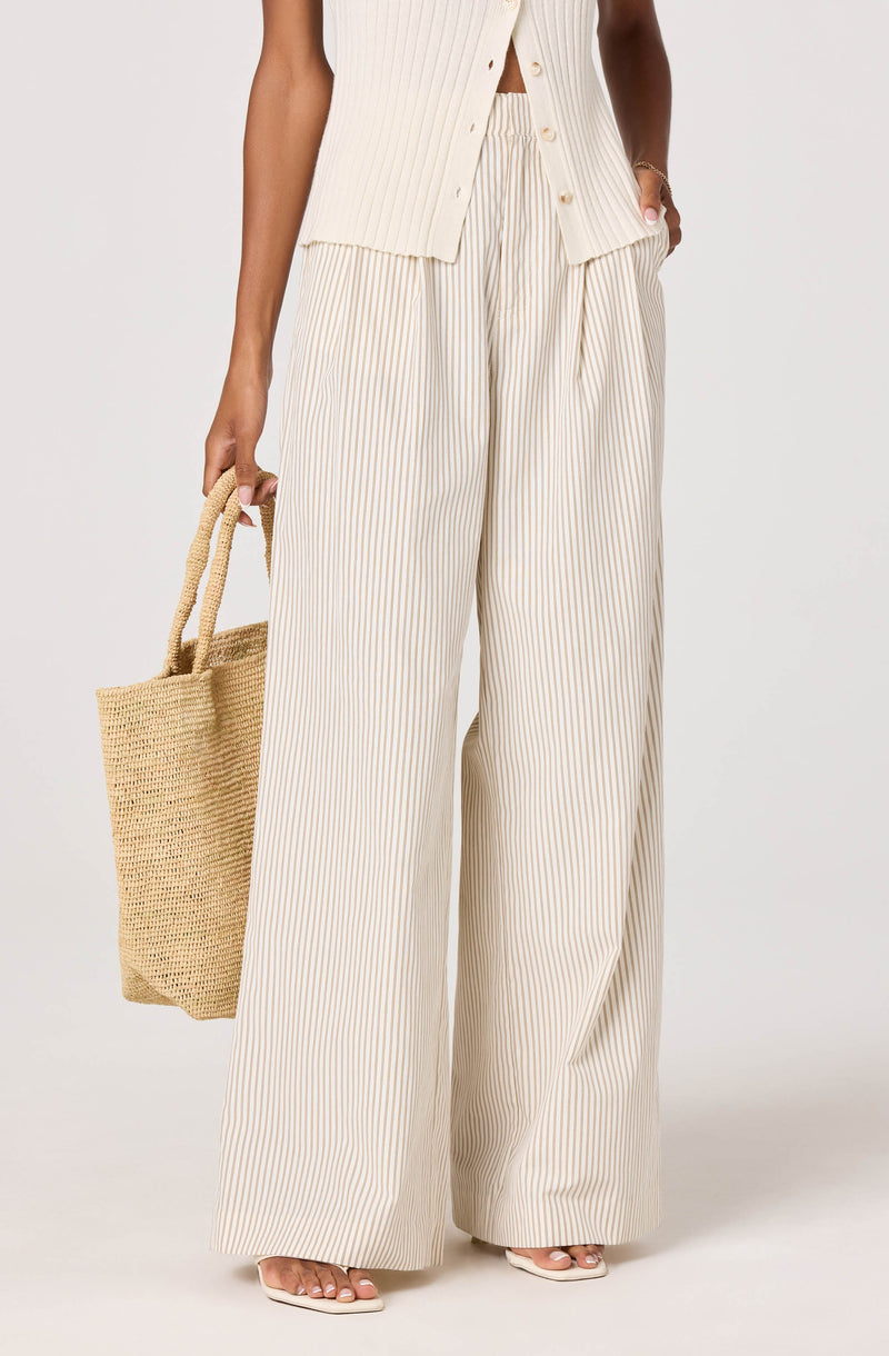 Cream and beige vertical striped wide-leg pants with a matching sleeveless vest.