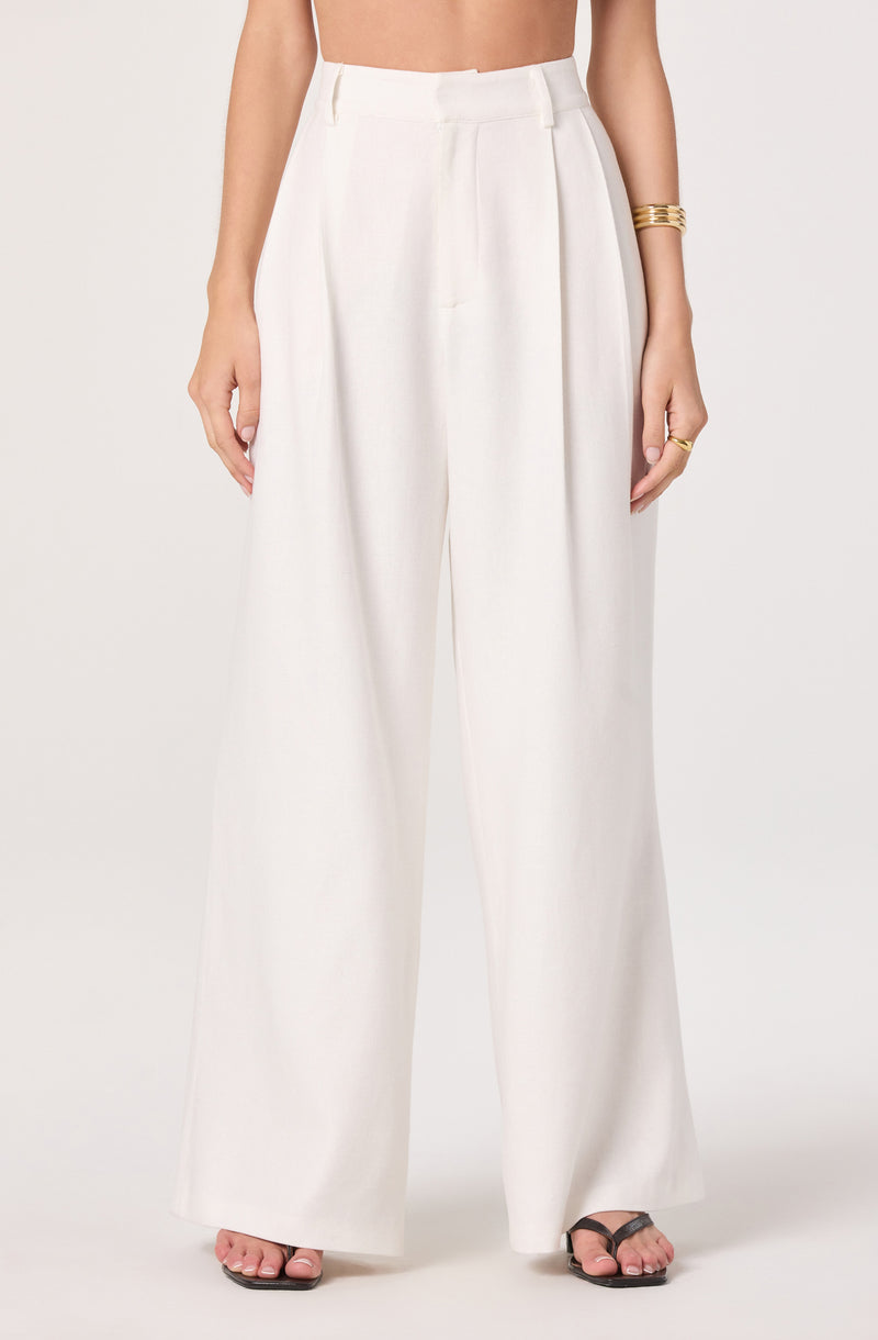 White wide-leg high-waisted trousers with pleats and belt loops.