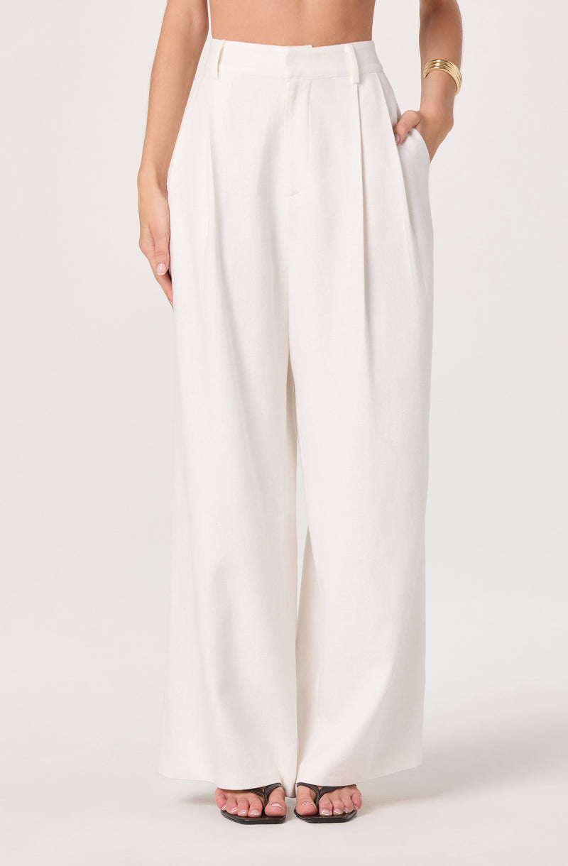 White wide-leg high-waisted pants with pleats and side pockets.