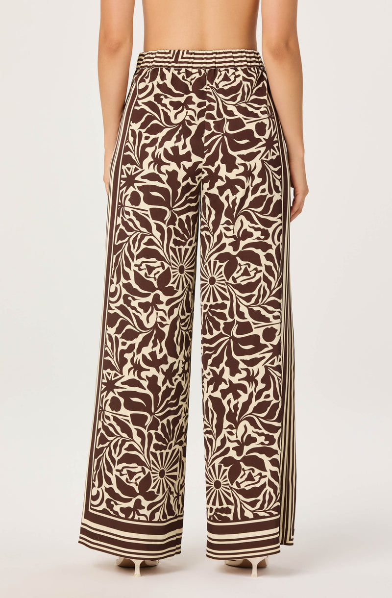 Wide-leg pants with a high waist, beige and dark brown floral and geometric pattern.