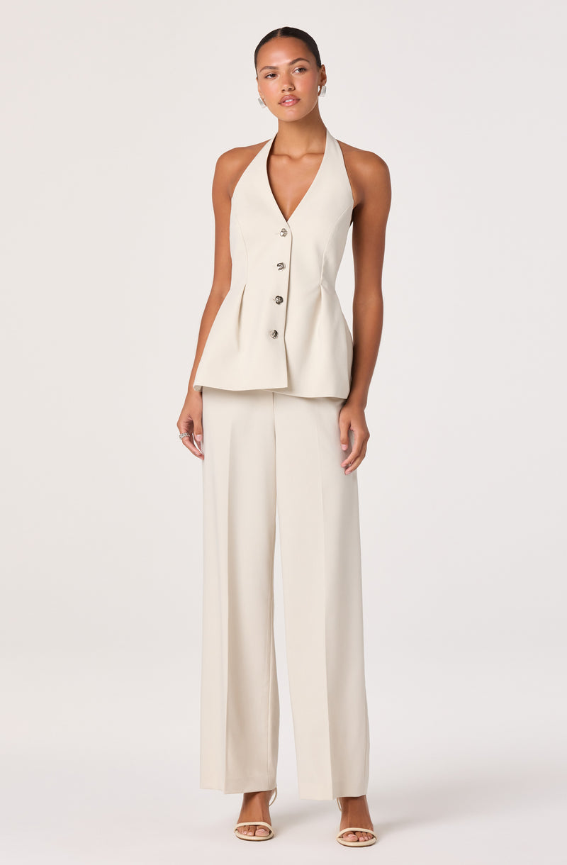 Cream sleeveless top with buttons and matching wide-leg trousers.