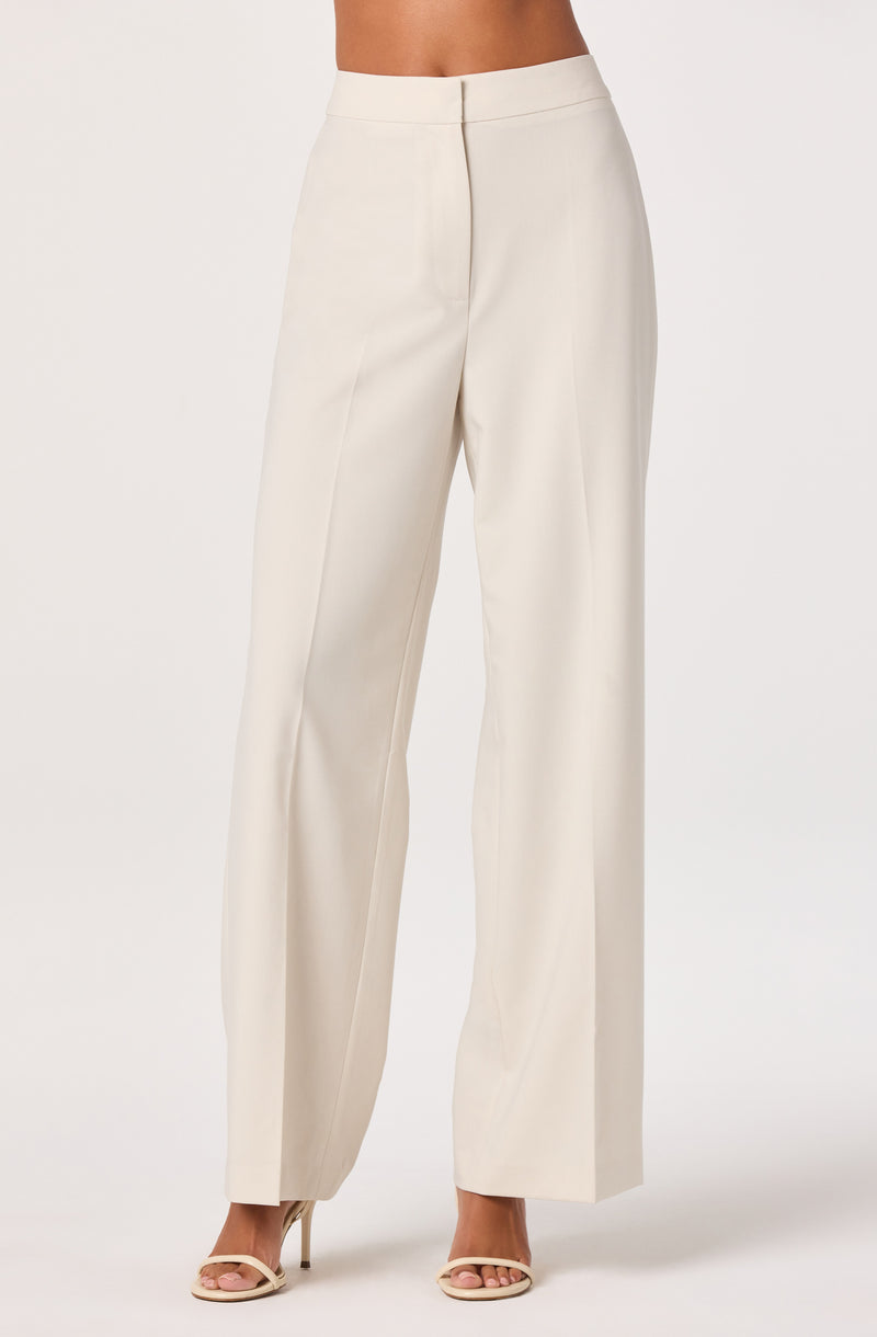 High-waisted cream wide-leg trousers with a front zipper and pleats.