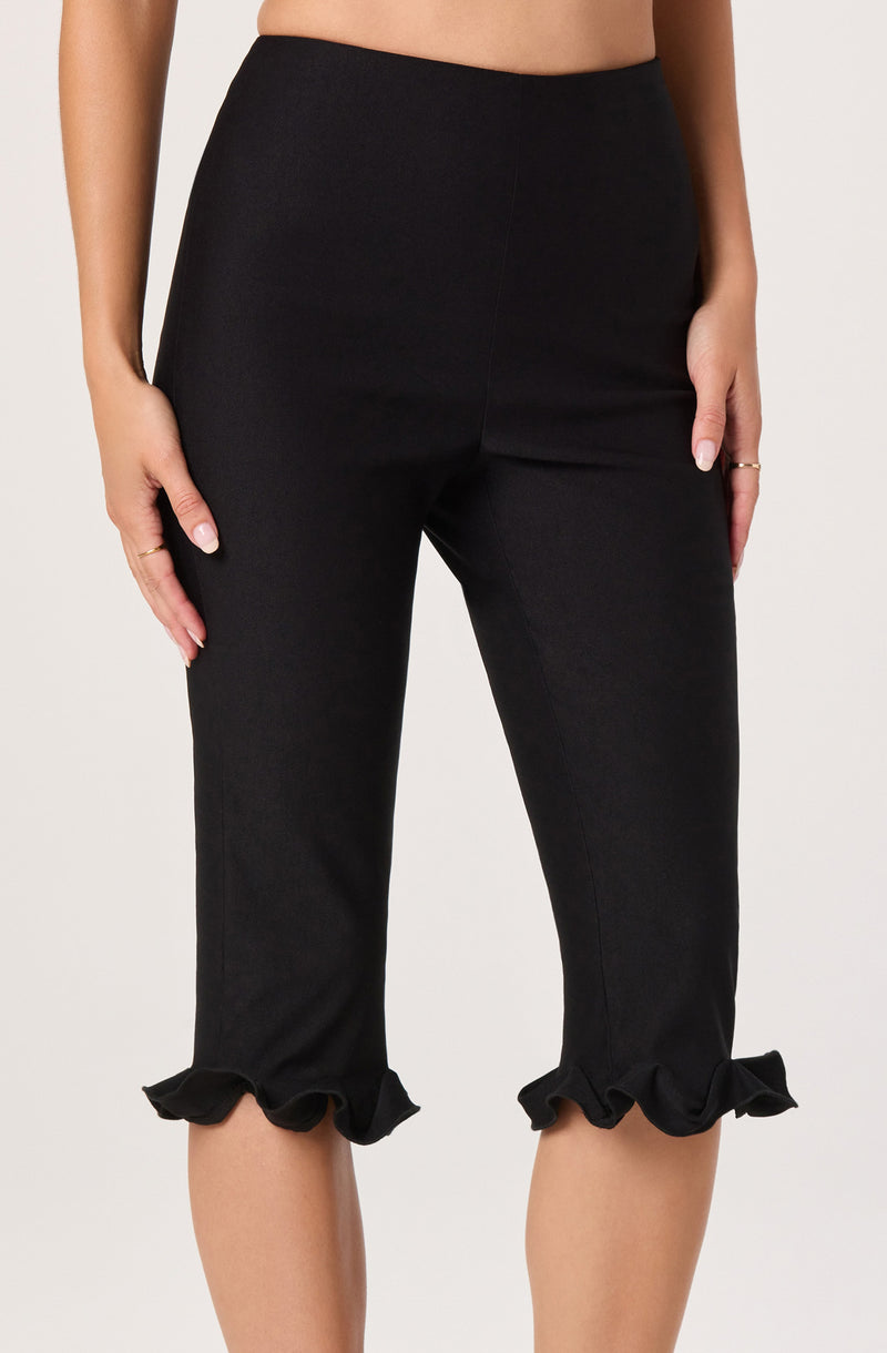 Black capri pants with ruffled hems at the bottom.