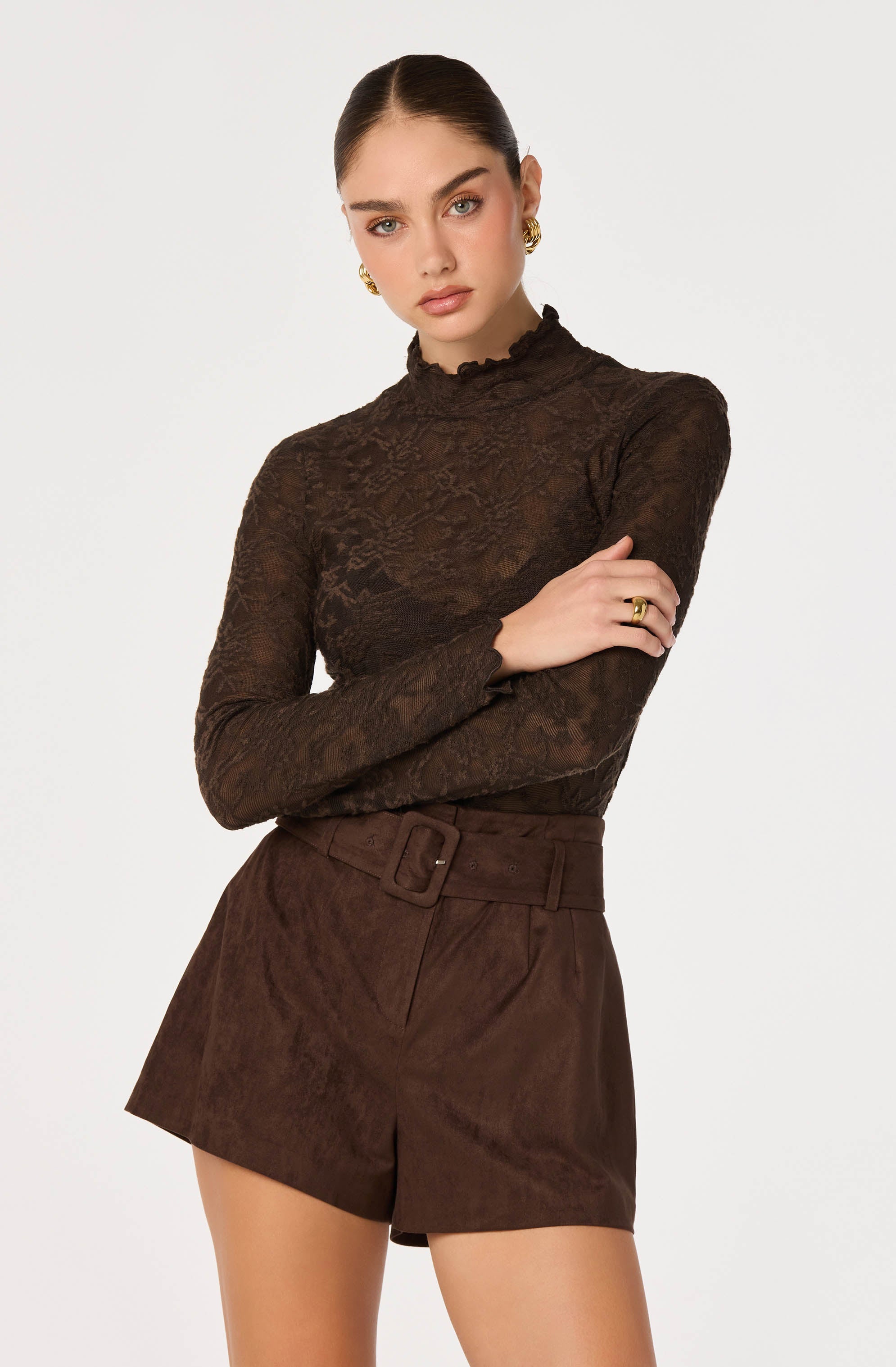 Model wearing a brown lace long-sleeve top and matching high-waisted shorts.