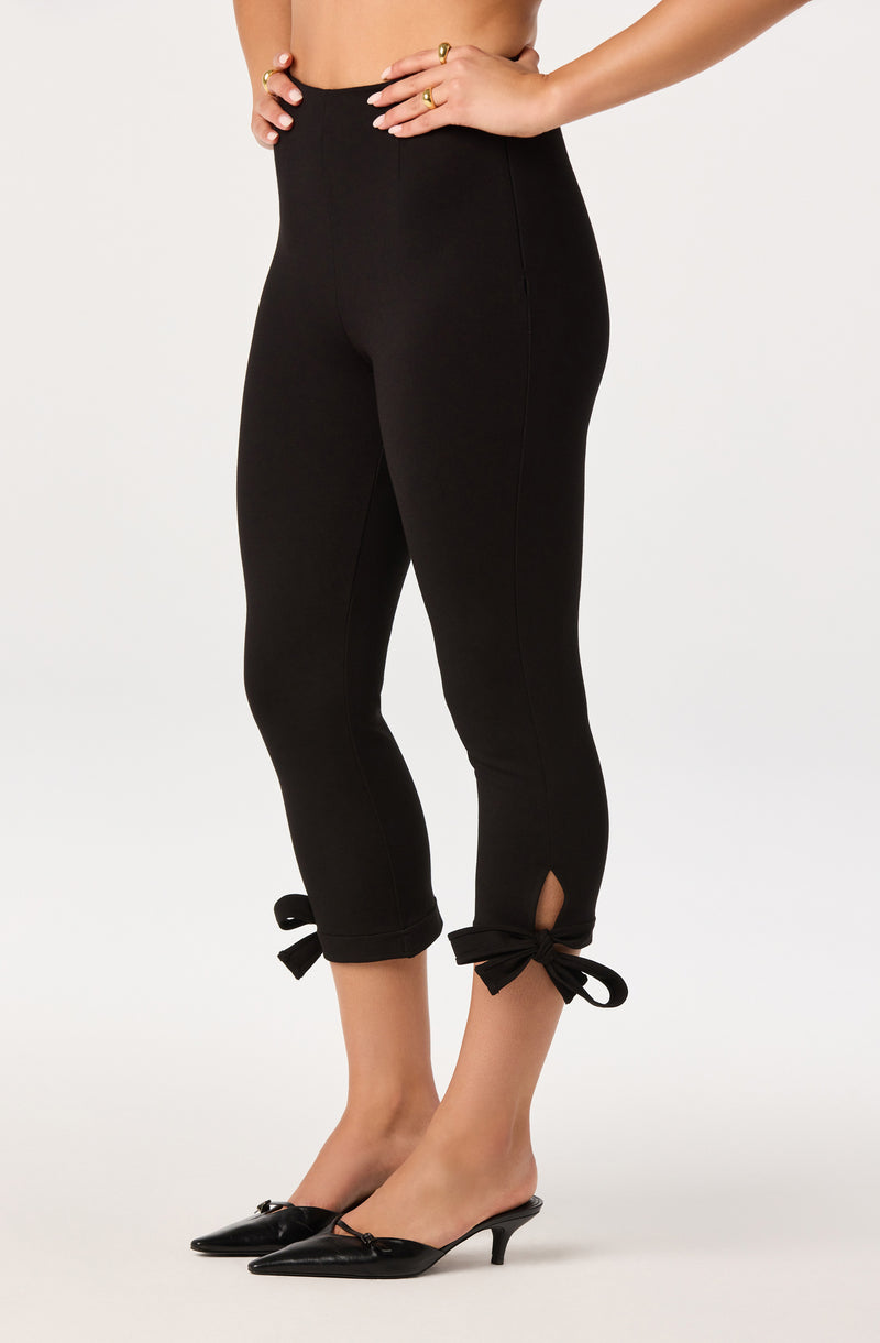 Black capri pants with bow ties at the hem and small side slit.