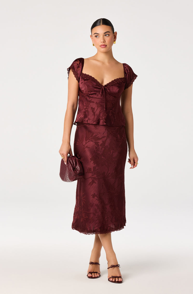 Women's burgundy satin lace dress with a floral pattern, ruffled cap sleeves, and a fitted skirt.