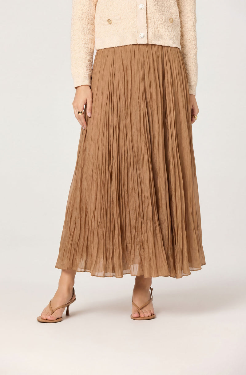 Long pleated brown skirt with a sheer, flowy texture.