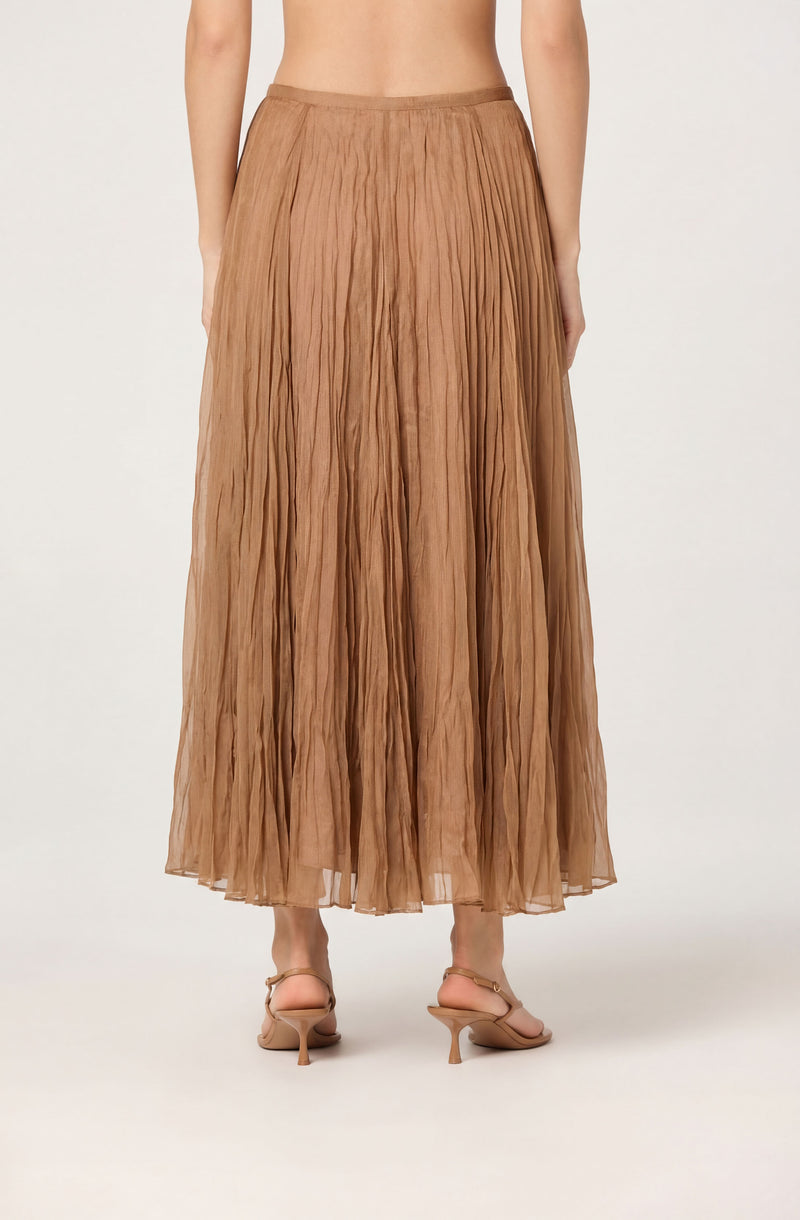 Long tan pleated skirt with a sheer, flowy texture.