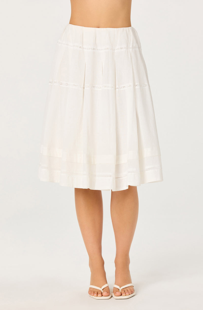 White midi skirt with horizontal lace trim details and a gathered, flowy design.